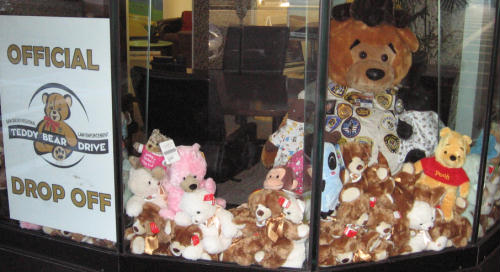 a pile of teddy bears in a window