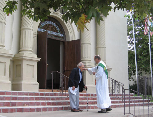 priest on steps of historic old town church