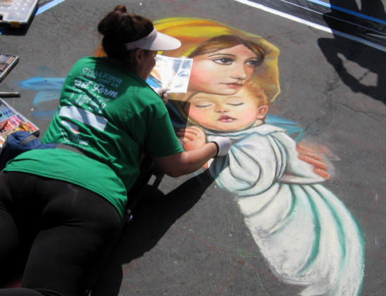 artist creates chalk madonna and child