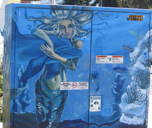 mermaid embraces dolphin on coronado island