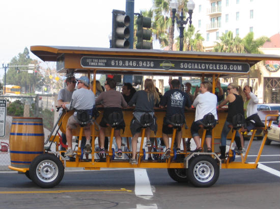 twelve-person bicycle heads down street