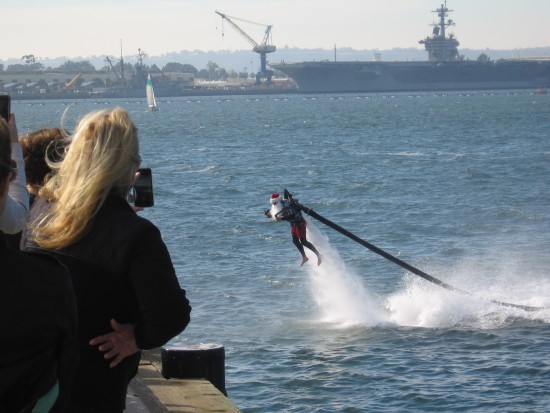 here comes santa claus with a water jetpack