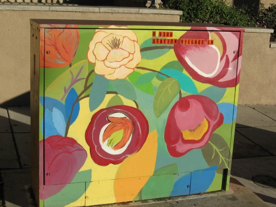 beautiful flowers decorate a utility box