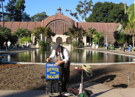sleeveless magician sets up in balboa park