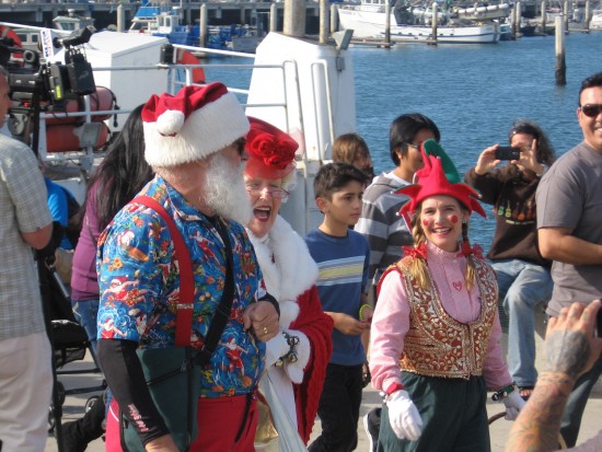 surfing santa walks down the pier for his reception