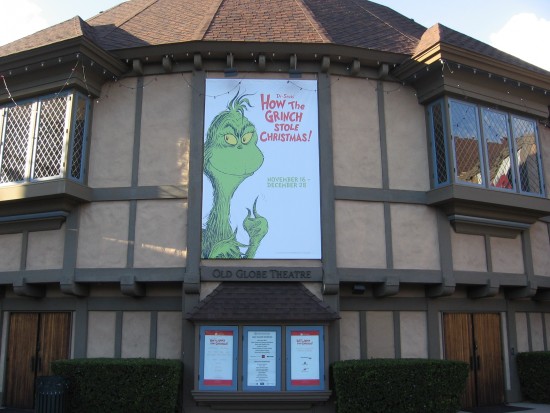 Front of the Old Globe Theatre features a banner of the Dr. Seuss Grinch.