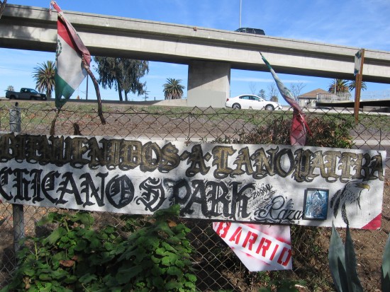 Chicano Park sign and Mexican flags beside Interstate 5.