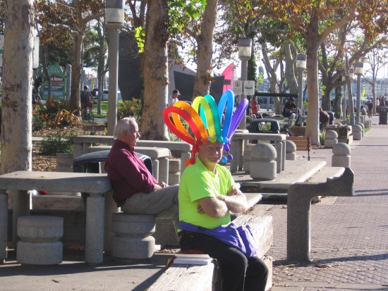 Balloon twister guy sits patiently on the Embarcadero.