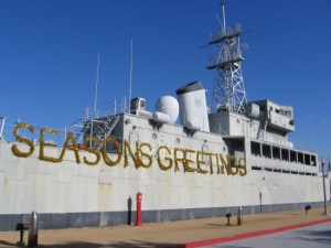 USS Recruit with Seasons Greetings sign.