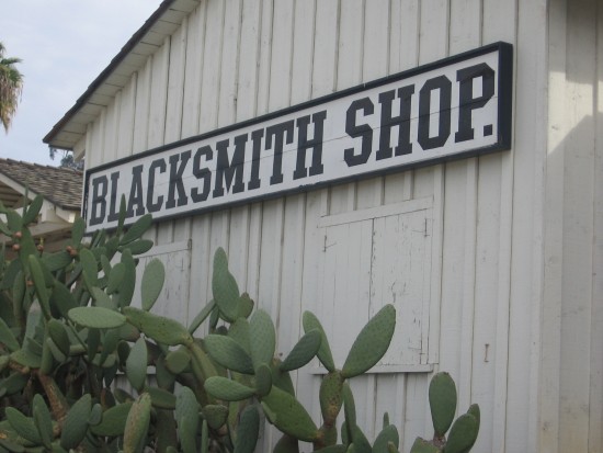 Sign on the Blacksmith Shop behind Seeley Stable.