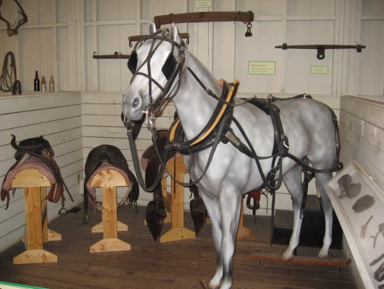 Museum display with horse and saddles recreates the old stable.