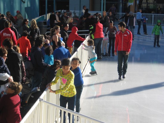 Beginning ice skaters hang on for dear life!