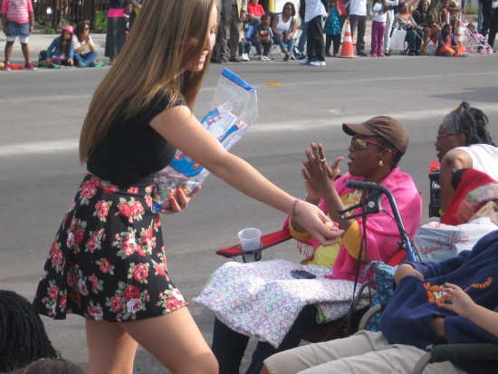 Goodies are handed out by an MLK Parade participant.
