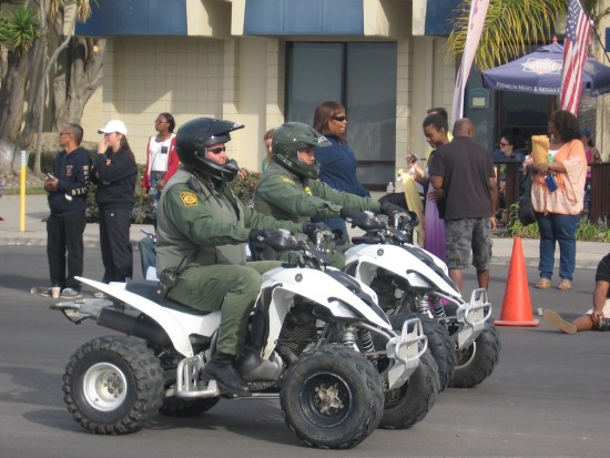 Border Patrol agents on all-terrain vehicles.