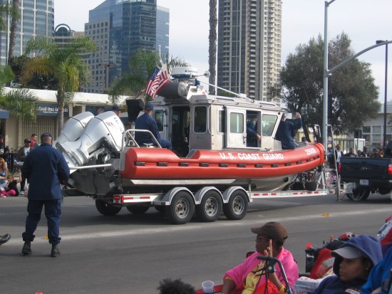 Coast Guard patrol boat towed along parade route.