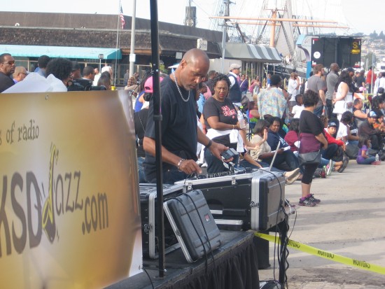 Attending to sound board beside the announcers.