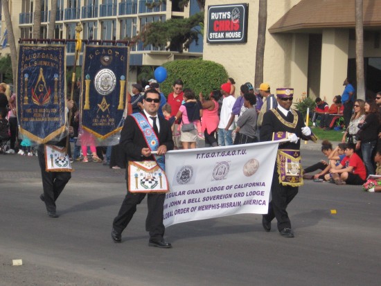 Members of a lodge parade on by to loud cheers.