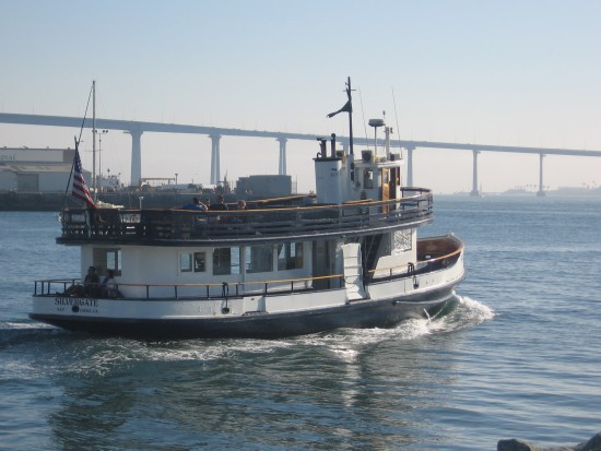 Silvergate ferry leaves for Coronado with bay bridge in background.