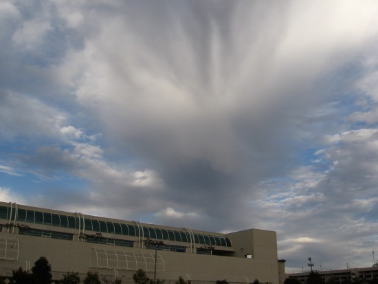 Windblown clouds radiate above San Diego Convention Center.