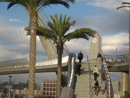 Bridge over Harbor Drive shines silver as folks ascend.