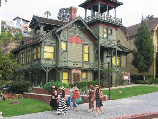 Group of ladies walking past the Sherman Gilbert House.