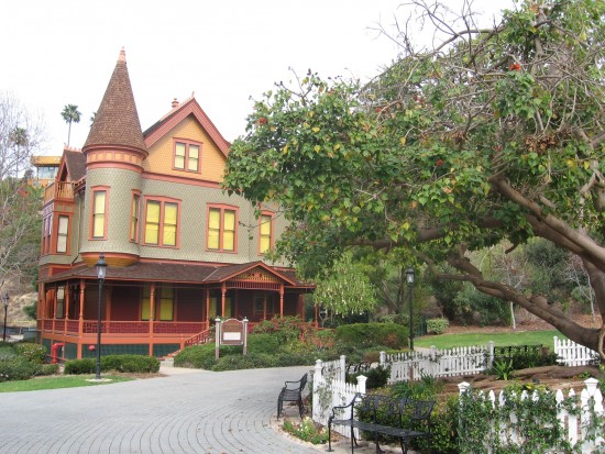 Christian House, built in 1889, seen beyond large tree.