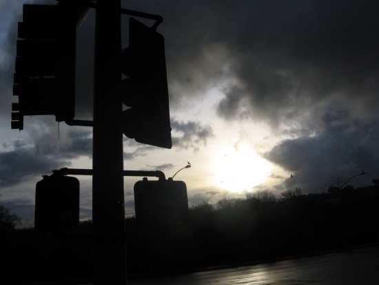 Dark morning rain clouds break for the rising sun.