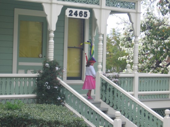 Girl on porch of the classic revival Burton House.