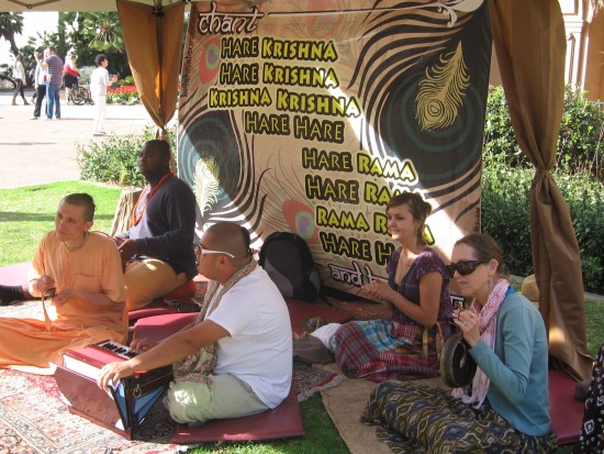 Hare Krishna advocates sit chanting their mantra.