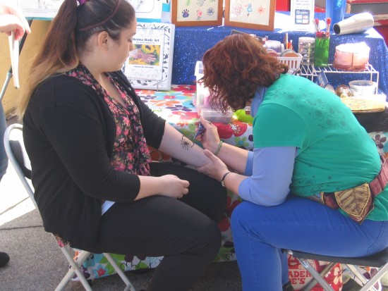 Henna tattoo applied to arm of Seaport Village visitor.