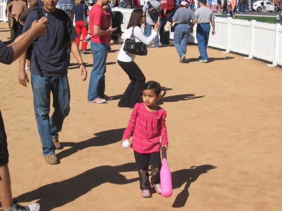 Small girl with a big pink baseball bat.