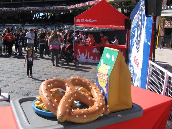 Small girl heads toward a big pretzel.