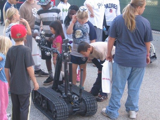 A military robot fascinates kids at Padres Fanfest.