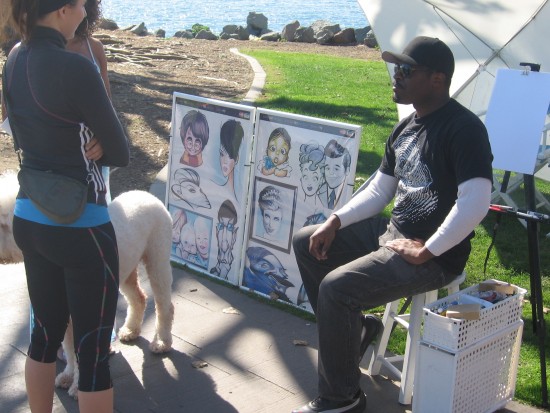 Passersby talk with a funny caricature artist.
