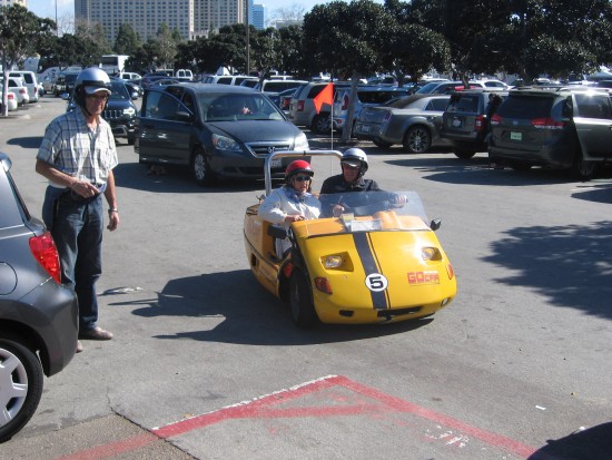 People in a tiny Go Car enjoy a GPS tour of San Diego.