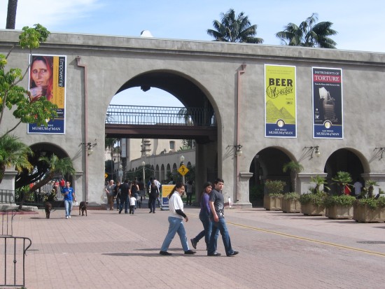 People walk through plaza in front of the Museum of Man.
