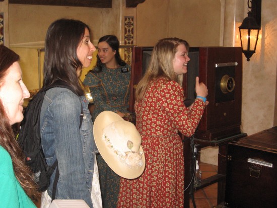 Taking pictures of visitors with a large old camera.