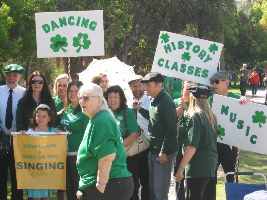 St. Patrick's Day Parade participants with signs.