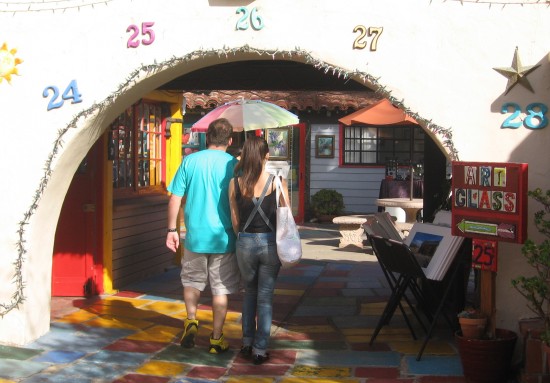 Couple explores folksy studios of Spanish Village.