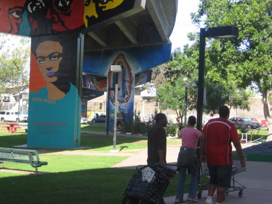 People walking through Chicano Park.