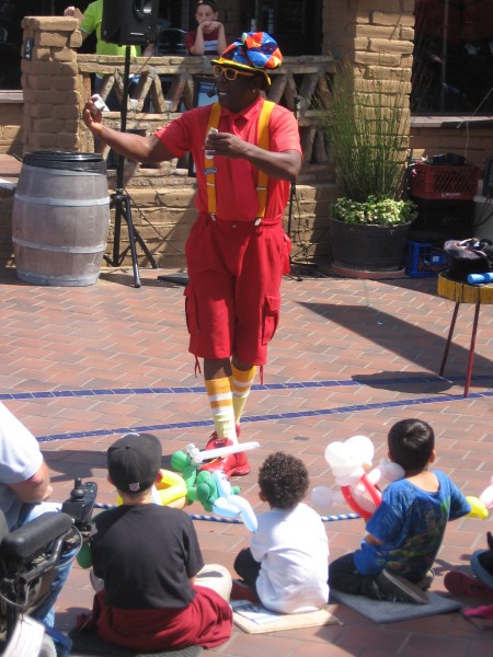 Funny magician wows kids at Seaport Village.