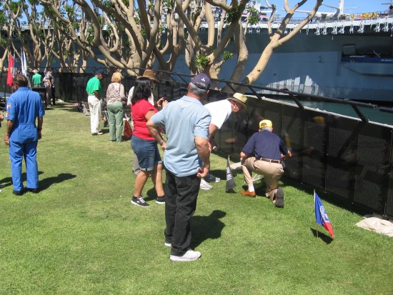 People read names inscribed on The Wall That Heals.