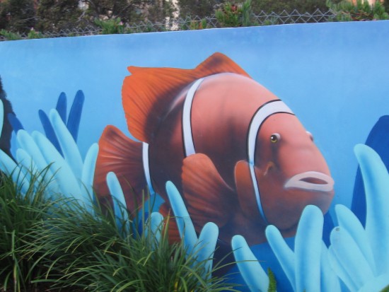 A bright orange fish swims through the city.