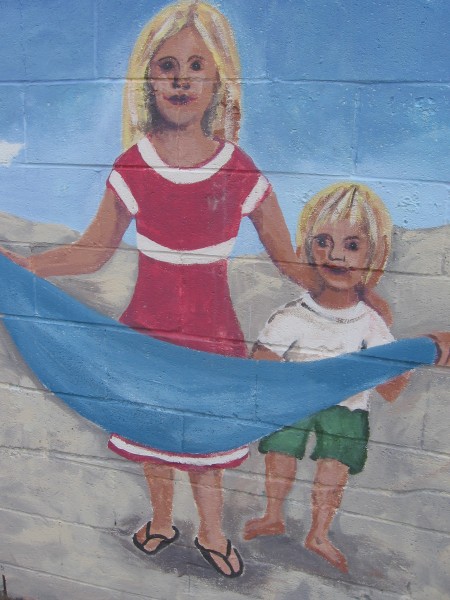 Happy faces at the beach on an outdoor mural.