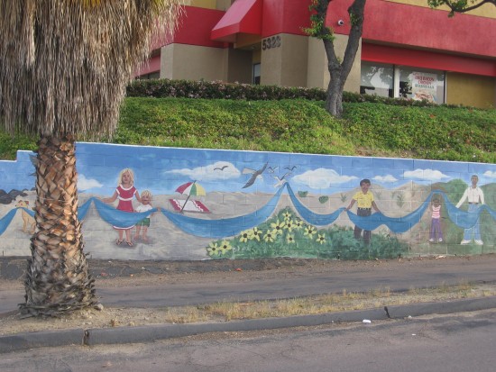 Colorful mural on parking lot wall near Carl's Jr.