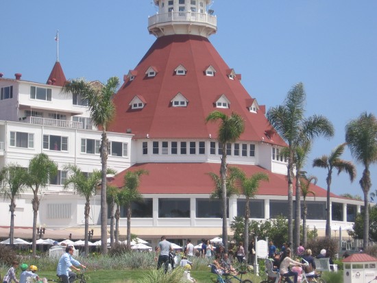 People enjoy the grassy area in front of the famous beach resort.