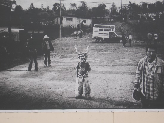 Photo of child in a mask is part of MOOPA mural.