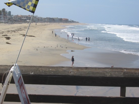 A few people on the beach on a spring weekday morning.