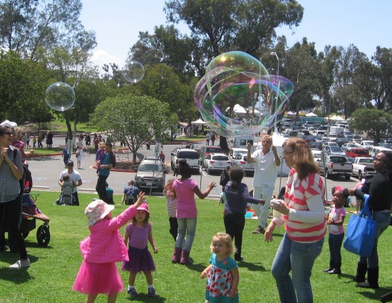 Kids have fun with great big bubbles.