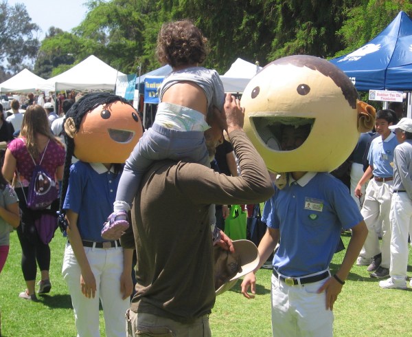Costumed characters greet a child at EarthFair.